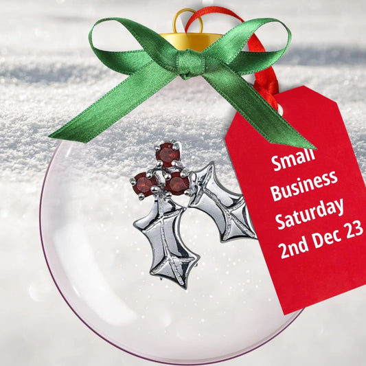 Small business Saturday tag on bauble featuring a garnet holly brooch