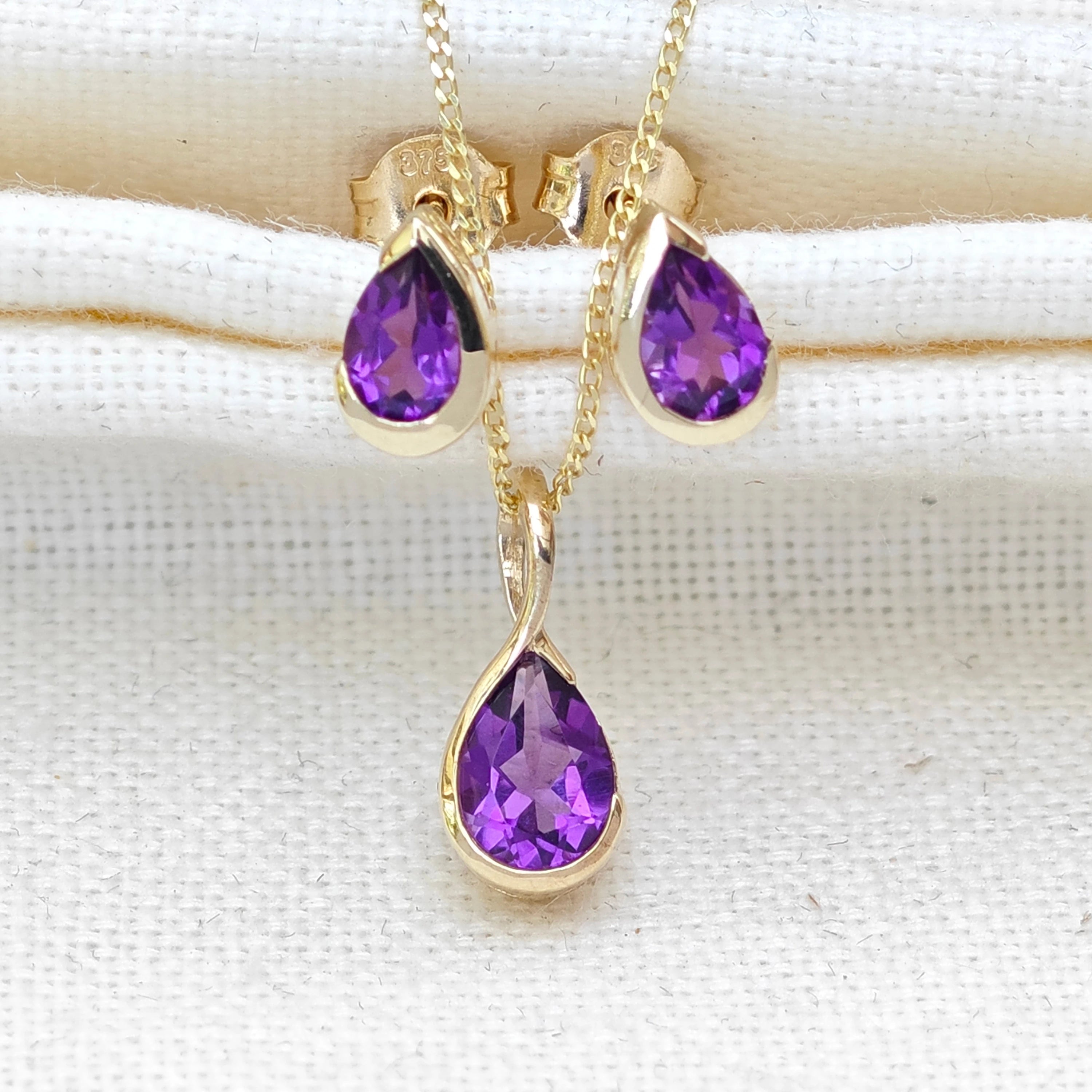 gold necklace and earrings set with amethyst