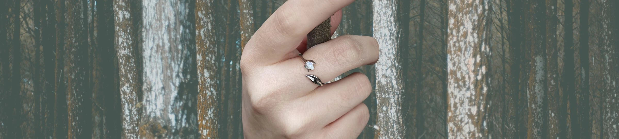 Tulip opal ring adjustable in sterling silver on wooded background