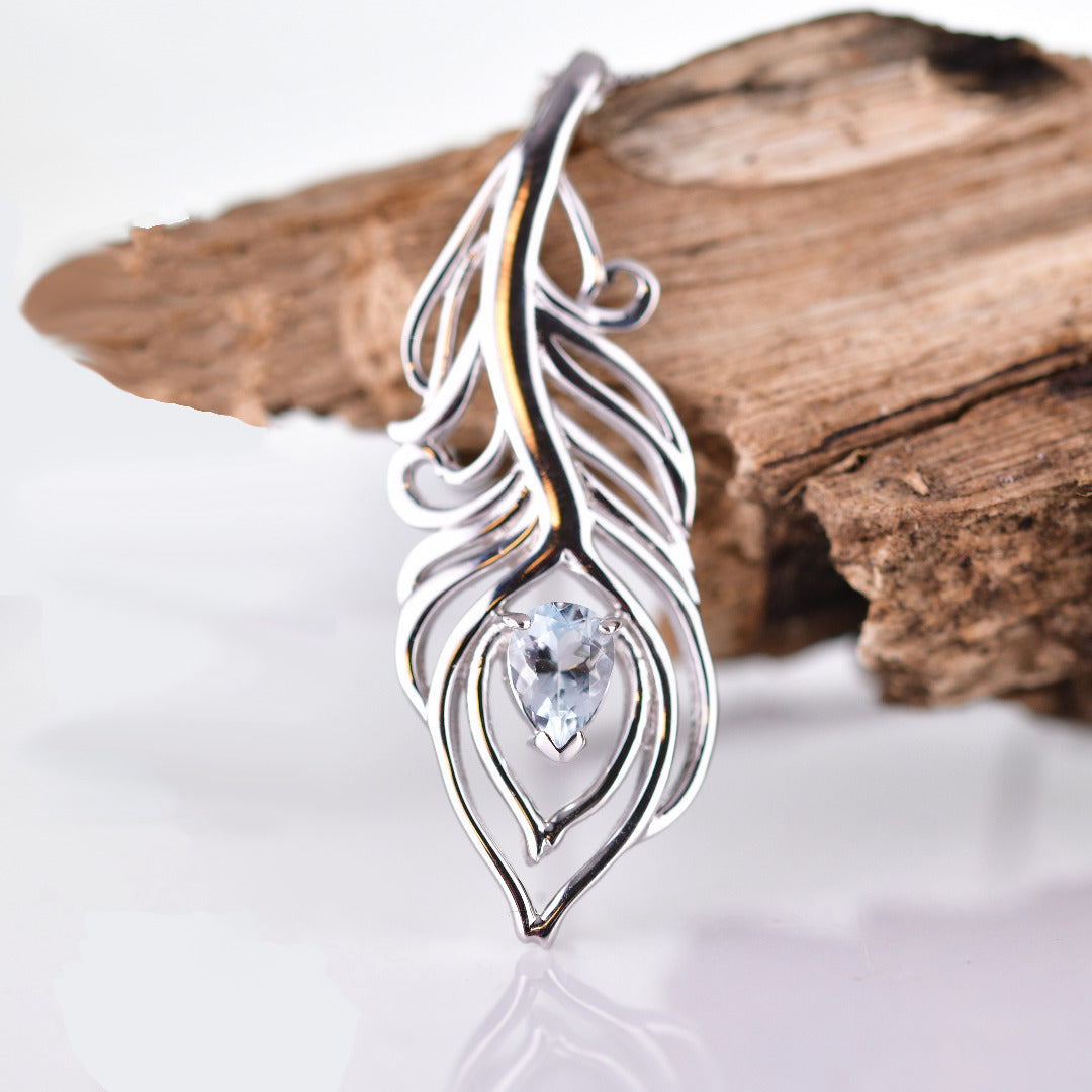 Aquamarine peacock feather statement pendant sterling silver on branch